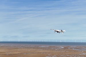 An Airspection drone flies towards an offshore wind farm